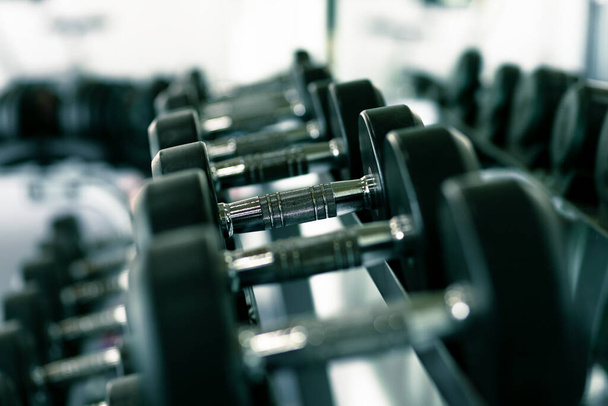 dumbbell set. Close up dumbbells on rack in sport fitness. - Foto, afbeelding