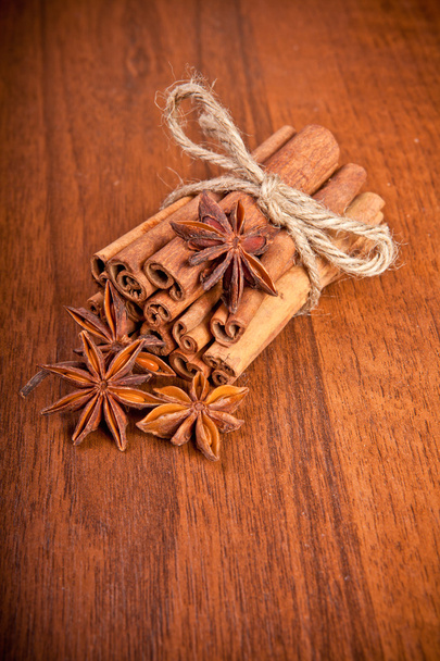 Cinnamon sticks and star anise on a wooden background - Valokuva, kuva