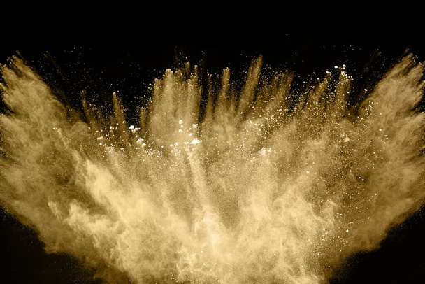 Esplosione di polvere dorata su sfondo nero. Movimento di fermo. - Foto, immagini