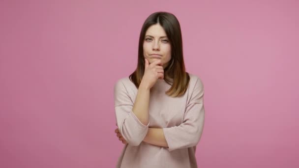 Excited brunette woman raising her finger in excellent idea, knowing answer, found smart solution and looking at camera with amazement, got inspiration. indoor studio shot isolated on pink background - Video