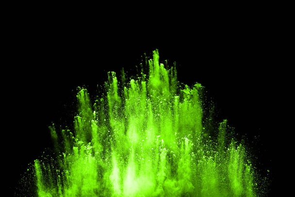 Green powder explosion on black background. Colored cloud. Colorful dust explode. Paint Holi. - Photo, Image