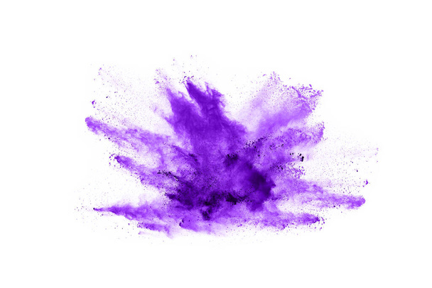 Powder explosion. Closeup of a purple dust particle explosion isolated on white. Abstract background. - 写真・画像