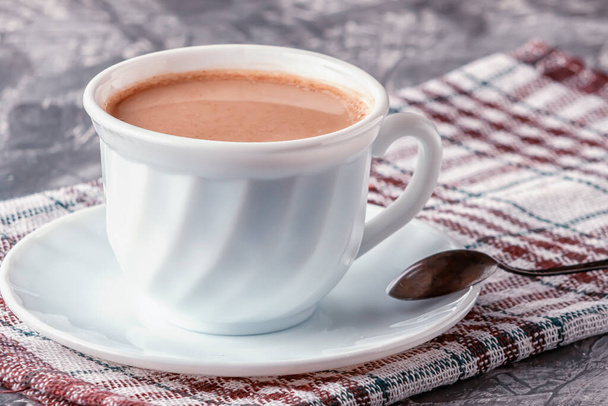On a gray background, freshly brewed aromatic coffee with cream - Φωτογραφία, εικόνα