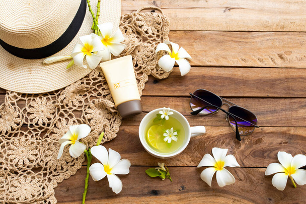 sunscreen spf50  cosmetics health care for skin face with crochet ,flowers frangipani ,sunglasses ,hat and herbal drinks lemonade of lifestyle woman relax in summer arrangement flat lay style - Photo, Image