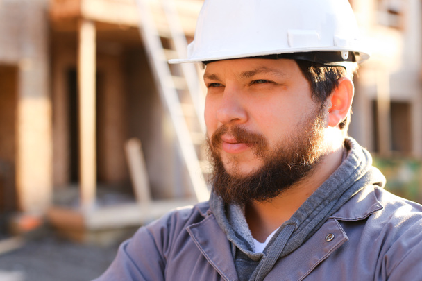 Close up portrait of construction manager and builder wearing hardhat. - Photo, Image