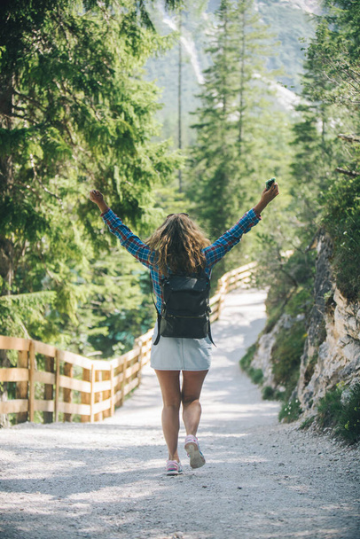woman with leather backpack hiking in national park near mountain lake. travel concept - Photo, Image