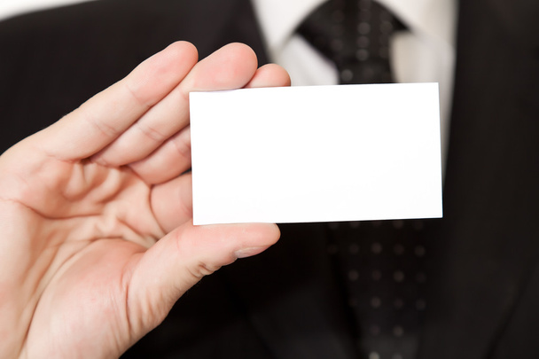 Business man holding blank card on white isolated background - Photo, Image