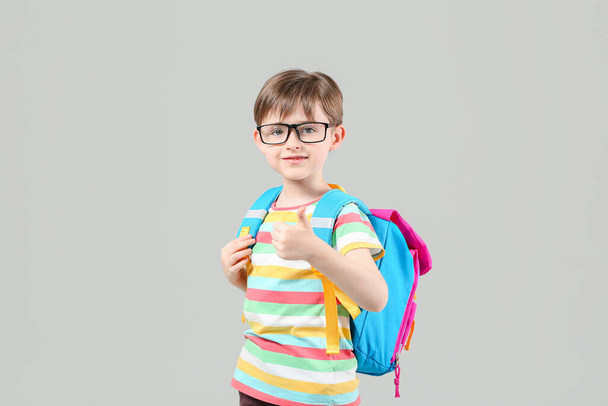 Cute little schoolboy on light background - Photo, Image
