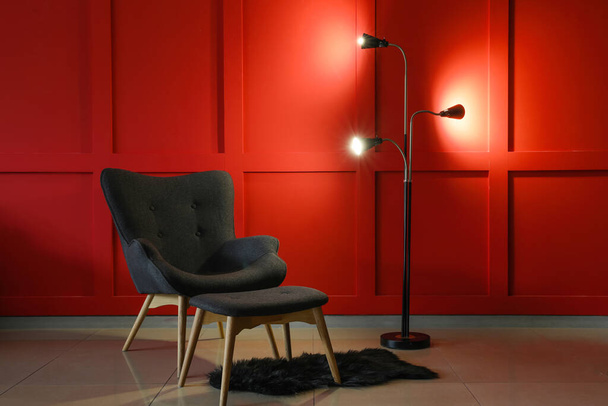 Зручне крісло і лампа в інтер'єрі вітальні
 - Фото, зображення