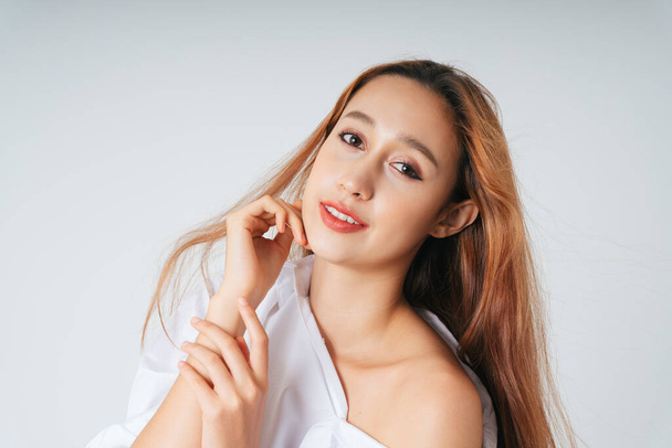 Beautiful woman in white shirt with natural make up isolated over white background. Skincare facial treatment concept. - Zdjęcie, obraz