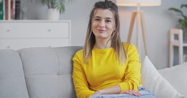 Close up front portrait of beautiful smiling confident young woman with pretty face looking at camera, posing alone at home office, happy professional millennial student girl. - Materiał filmowy, wideo