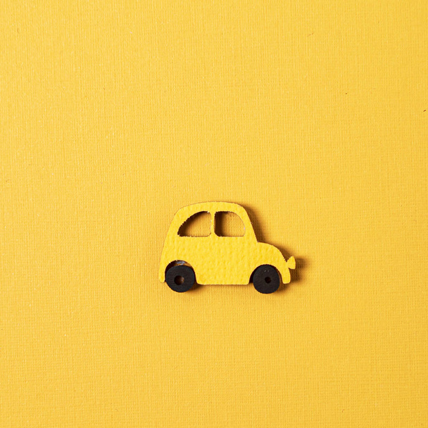 yellow wooden car on the yellow background - Zdjęcie, obraz