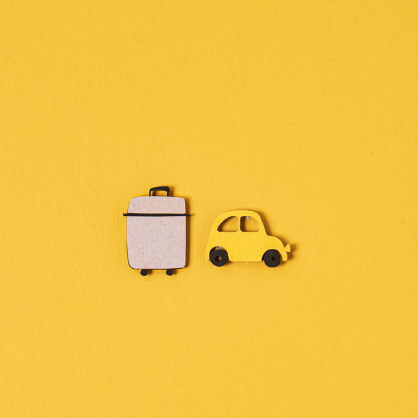 yellow wooden car and suitcase, top view - Photo, Image