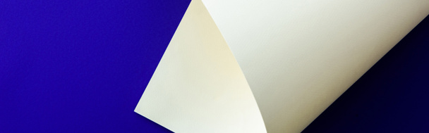 white colorful paper swirl on blue background, panoramic shot - Φωτογραφία, εικόνα