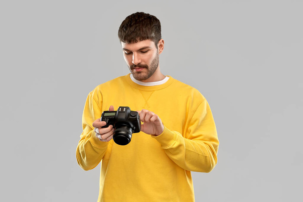 young man with digital camera - Фото, зображення