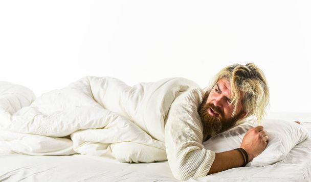 Interrupted sleep. Sleep concept. Regularly sleeping more than suggested amount may increase risk of obesity headache back pain and heart disease. Nap and sleep. Man sleepy face lies on pillow - Fotoğraf, Görsel