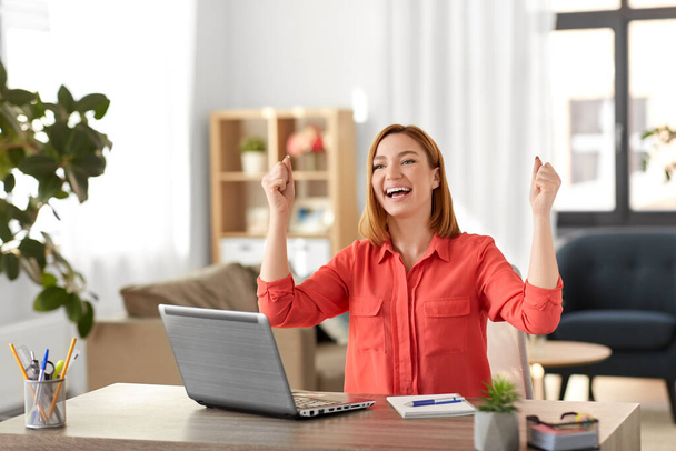 happy woman with laptop working at home office - Foto, Imagem