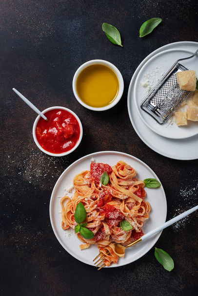 Tradiční italské těstoviny s rajčaty, bazalkou a parmezánem. Obrázek horního pohledu s mezerou pro kopírování - Fotografie, Obrázek