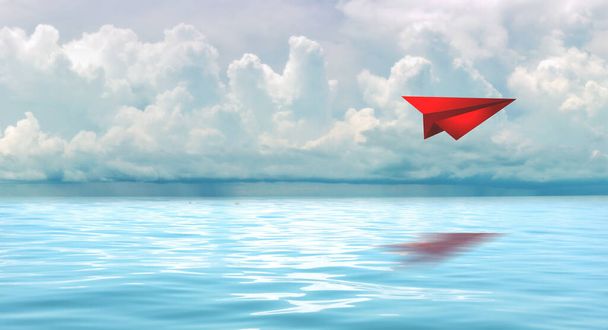 Red paperplane in the beautiful seascape with cloud on a sunny day. - Photo, Image