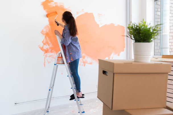 Lovely woman painting wall. Renovation, redecoration and repair concept. - Fotografie, Obrázek