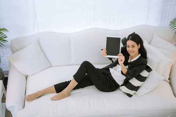 Asian woman using phone shopping online website on smart tablet hand point touch screen digital tablet. Woman holding smartphone checking mail online shopping website read article vlog social media - Foto, Imagem