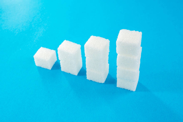 degree with sugar cubes on a blue background. diabetes mellitus. - Photo, Image