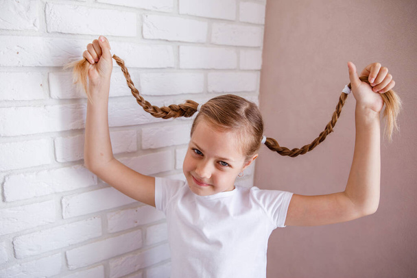 braided hair. Cute Little girl with two pigtails - Foto, immagini