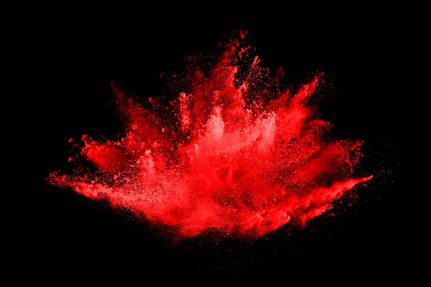 Abstract red powder explosion on black background.abstract red powder splatted on black background. Freeze motion of red powder exploding. - Foto, afbeelding