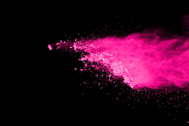 abstract pink powder splatted background,Freeze motion of color powder exploding/throwing color powder,color glitter texture on black background. - Photo, Image