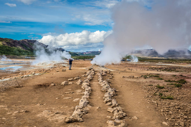 Hverir, Iceland - June 19, 2018: Hverir geothermal area with boiling mudpools and steaming fumaroles - Фото, зображення