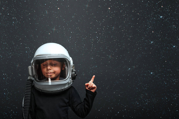 Small child wants to fly an airplane wearing an airplane helmet. effects glitch - Zdjęcie, obraz