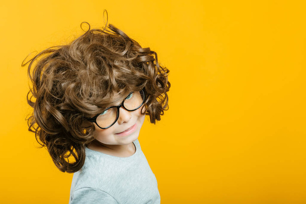 model child posing on yellow background - Foto, afbeelding