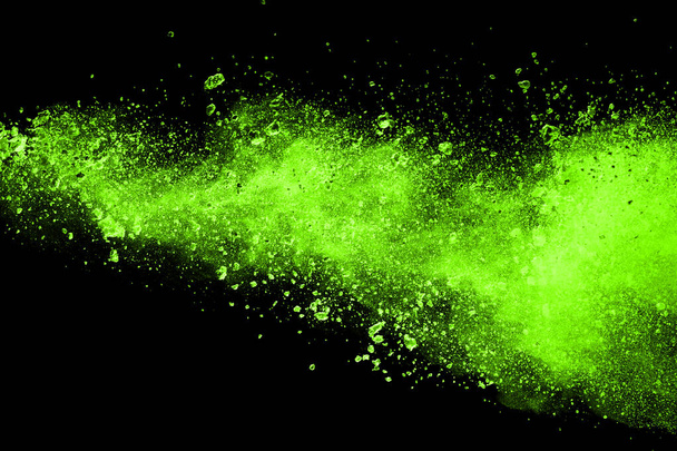 Green powder explosion on black background. Colored cloud. Colorful dust explode. Paint Holi. - Foto, Imagem