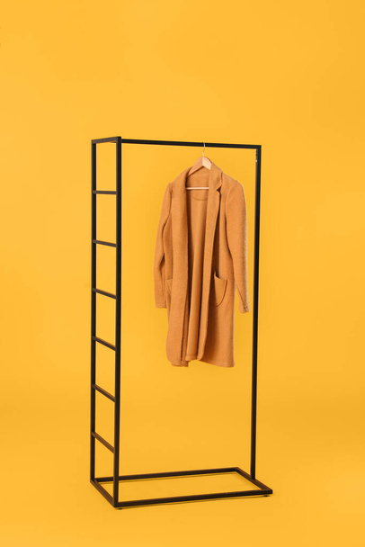 Stylish hanger with female clothes on color background - Photo, image