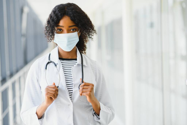 female doctor with stethoscope on hospital corridor holding clipboard with an operating room at the background ,Healthcare and medical concept,selective focus. - Fotó, kép