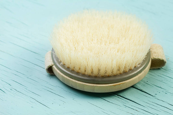dry massage wooden body brush for skin care at home isolated on a blue background - Photo, Image