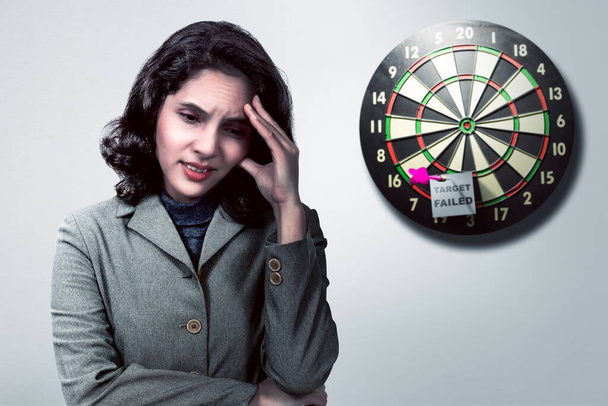 Asian businesswoman feeling depressed with the text of target failed in the darts on the wall background - Foto, immagini