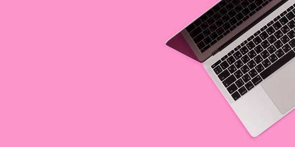 Beauty office desk with laptop notebook on pink background top view - Fotografie, Obrázek