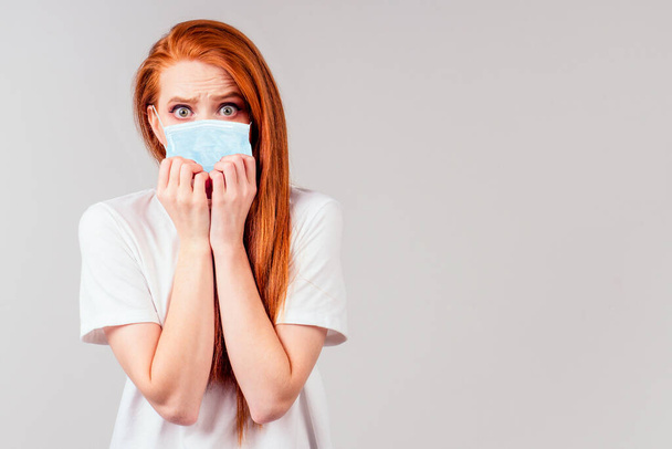 redhair ginger woman feeling unhappy and wearing medical mask - Foto, immagini
