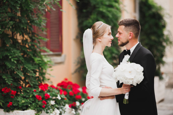 Gorgeous happy couple standing close to each other and looking in eyes - Фото, изображение