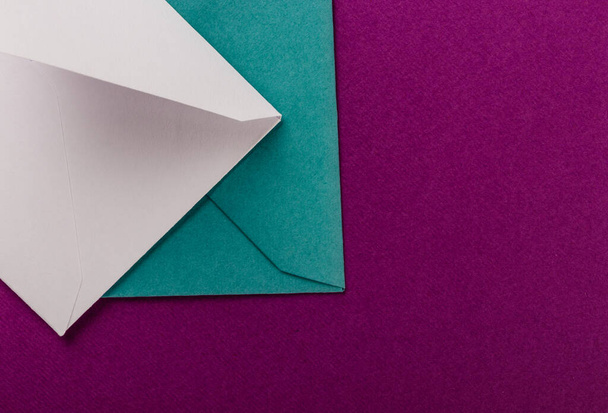 Colorful envelopes on a purple background. Mail envelopes on the table. - Fotoğraf, Görsel