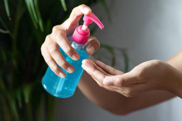 Female hand pressing bottle and pouring alcohol-based sanitize on hands.and the white and green wall Alcohol Hand washing Anti-virus and anti-virus Covid-19. Disinfection concept. Liquid soap with squeeze. 3d illustration.select focus. - Zdjęcie, obraz