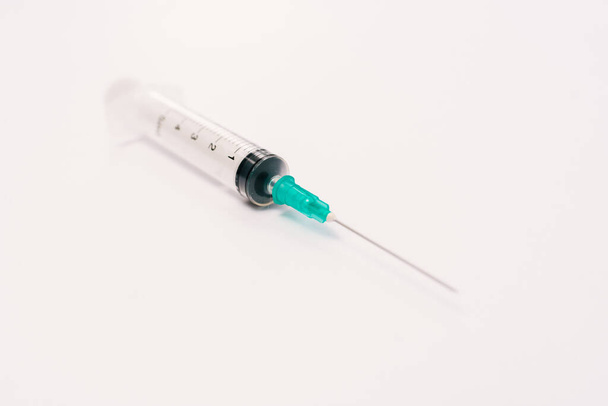 Stock photo of a syringe needle on a white background. There is nobody on the picture. - Photo, Image