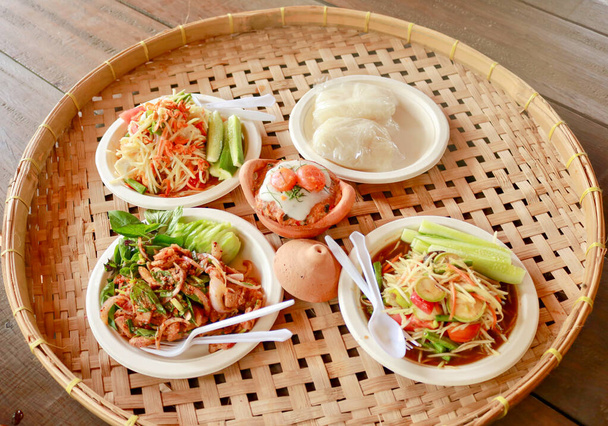 Papaya salad, grilled chicken and Sai krok isan Thai food. on Woven tray.  in the northeastern provinces of Thailand. - Photo, Image