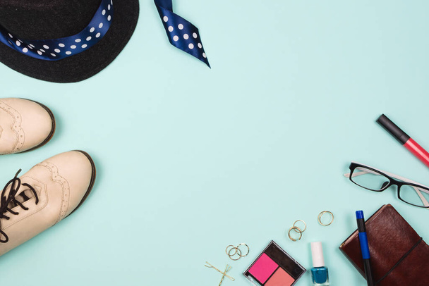 Beautiful fashion flatlay arrangement with various fashion accessories: glasses, cosmetics, jewelry, rings, shoes etc. Mint background. Concept of getting ready to go out. Copyspace - Photo, Image