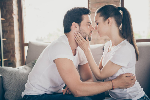Profile photo of charming lady handsome guy couple relaxing comfy eyes closed stay home good mood kissing hugging touching quarantine spend time together living room indoors - Photo, Image