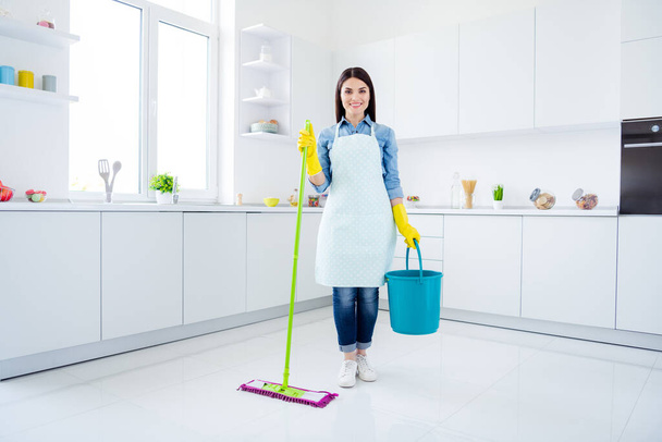Full length photo of positive confident woman housewife hold bucket mop ready clean room floor disinfect covid-29 infection in house kitchen indoors - Fotografie, Obrázek