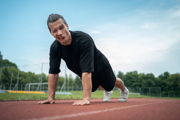 athletic sportsman has workout and planking outdoor - Φωτογραφία, εικόνα