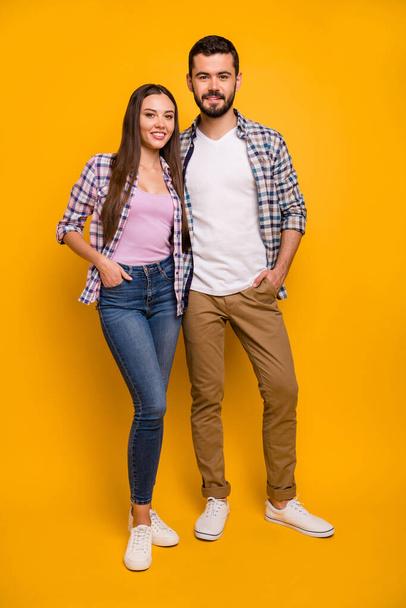 Full length vertical photo attractive lady handsome guy couple self-confident two people friendly team hugging good mood wear casual plaid shirts jeans shoes isolated yellow color background - Foto, Imagen