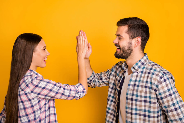 Profile side photo of excited spouses man woman take party sport match celebrate victory hold hand gesture high five wear good look outfit isolated over bright shine color background - Фото, зображення